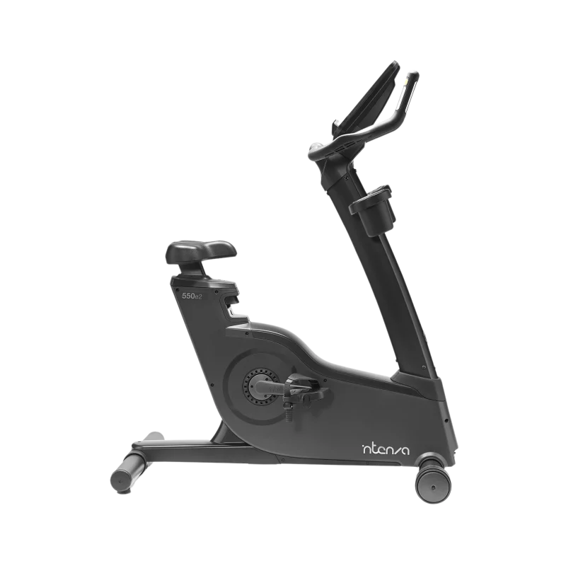 Person using the Intenza 550UBe2+ Upright Bike, demonstrating proper form and highlighting its comfortable and adjustable seat. A top choice for fitness in Dubai, UAE