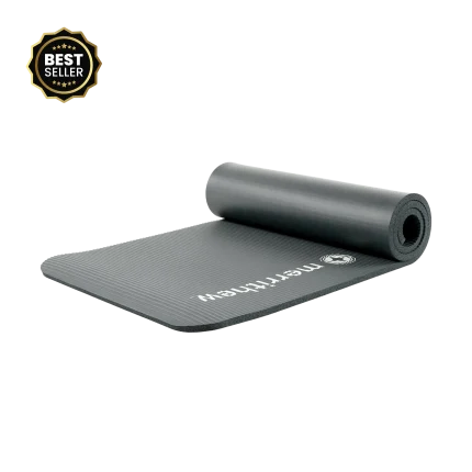 The Merrithew Deluxe Pilates Mat in Graphite laid out in a well-equipped Dubai Pilates studio, showcasing its thickness and smooth surface for comfortable workouts in the UAE.