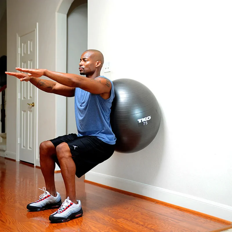 Person performing a plank exercise on the TKO Fitness Ball 75cm, demonstrating its effectiveness for core strengthening and balance in Sharjah, UAE.