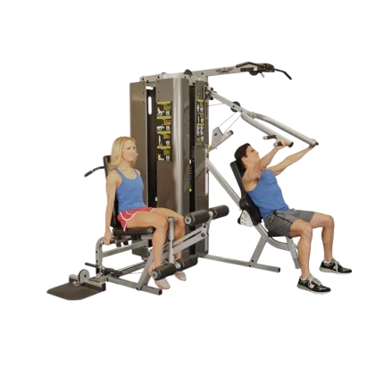 An individual performing a lat pulldown exercise on the Inflight Vanguard Multi Gym, showcasing its capability for back development, a key aspect of balanced physique training popular in the UAE. The user grips the wide bar, pulling it down smoothly while secured by the adjustable leg pads. This demonstrates one of the core functions of this versatile multi-station machine, appealing to users in Dubai, Abu Dhabi, and Sharjah seeking an all-in-one solution for hitting major muscle groups, available for purchase and delivery across the Emirates in AED.